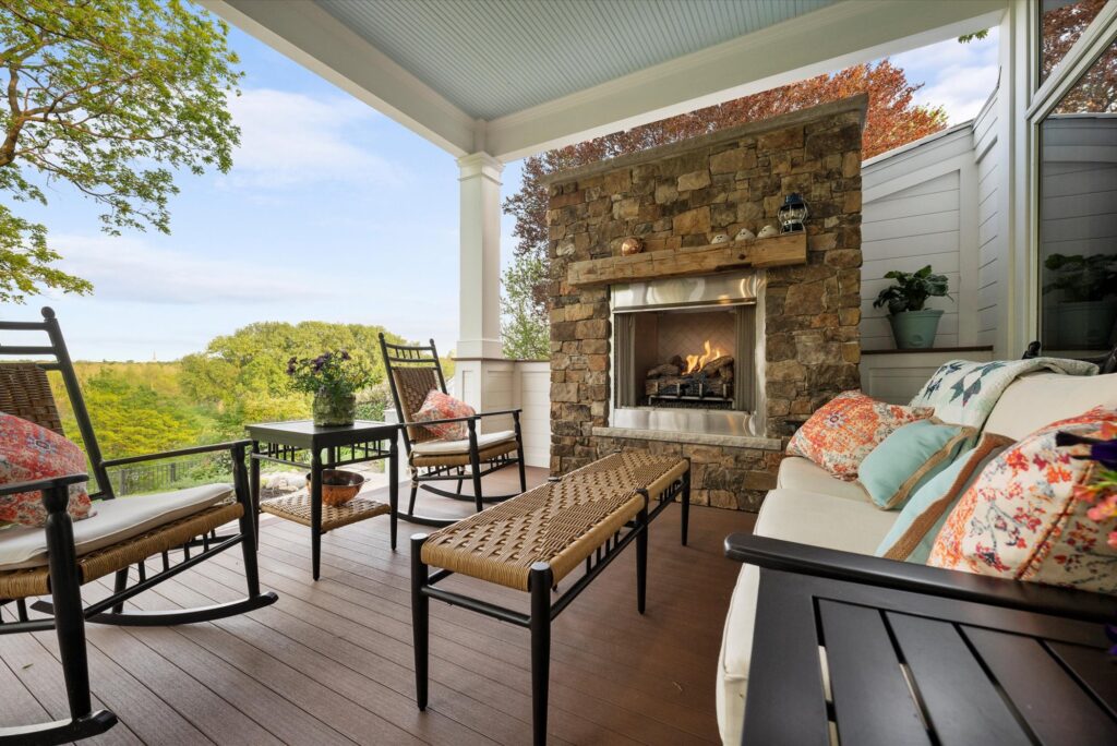 Outdoor fireplace surrounded by cozy seating on a Signature Decks project